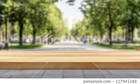 Empty Wooden Table Shows Blurry Park Background with Green Trees and Walkway for Summer Product Display 127941288