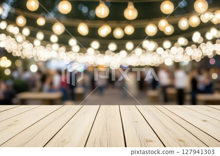 Empty Wooden Table Presents Blurred Lights and Festive Crowd. Celebration, Gathering, Community, Background, Event. Outdoor Party Space with Lights and Tables. 127941303