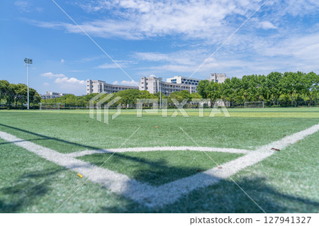 University campus football field under blue sky and white clouds 127941327