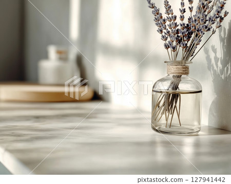 Glass bottle with lavender stems in aromatic oil Glass bottle with lavender stems in aromatic oil 127941442