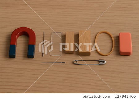 Assortment of everyday objects including a magnet, needle, and safety pin Assortment of everyday objects including a magnet, needle, and safety pin 127941460