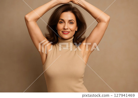 Portrait of Woman Raising Hands Above Head Showing Freedom and Joy 127941469