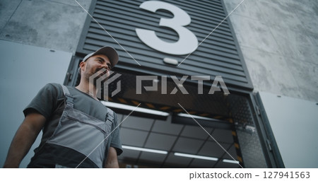 Logistics Retail Warehouse: Worker Giving Cardboard Box to Employee of Express Delivery Service Logistics Retail Warehouse: Worker Giving Cardboard Box to Employee of Express Delivery Service 127941563