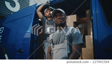 Portrait of Multiethnic Workers Standing Outside of Logistics Retail Warehouse, Looking at Camera Portrait of Multiethnic Workers Standing Outside of Logistics Retail Warehouse, Looking at Camera 127941564