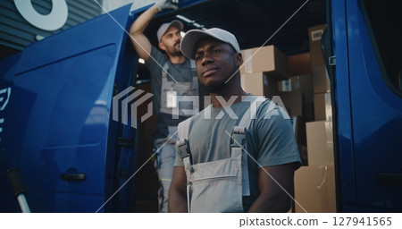 Portrait of Multiethnic Workers Standing Outside of Logistics Retail Warehouse, Looking at Camera Portrait of Multiethnic Workers Standing Outside of Logistics Retail Warehouse, Looking at Camera 127941565