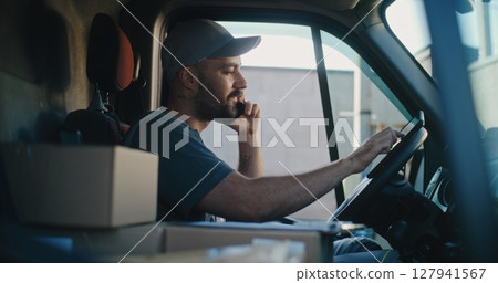 Product Supplier in Truck Talking by Mobile Phone with Customer, Filling Out Papers, Using Tablet Computer 127941567