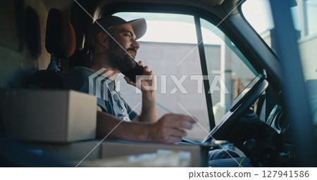 Product Supplier in Truck Talking by Mobile Phone with Customer, Filling Out Papers, Using Tablet Computer 127941586