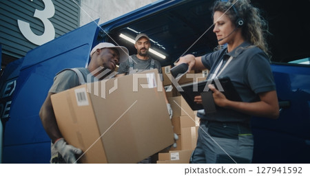Multiethnic Workers Loading Cardboard Boxes in Delivery Truck. Female Manager Using Barcode Scanner 127941592