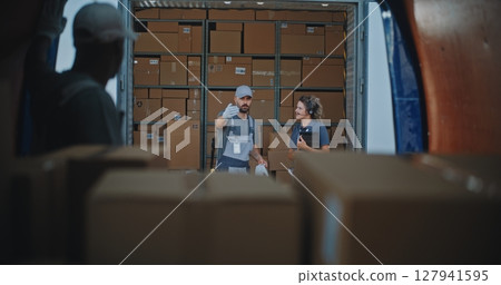 Multiethnic Workers Unloading Cardboard Boxes with Online Orders from Delivery Truck 127941595