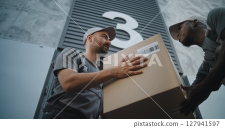 Employee Taking Cardboard Box from Worker of Express Delivery Service 127941597