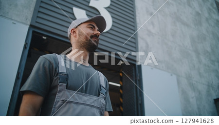 Logistics Distribution Warehouse: Employee Giving Cardboard Box with Online Orders to Loader 127941628