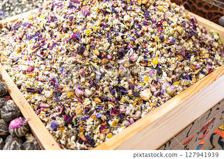 Colorful dried flower petals and herbs in wooden box. Beauty, health benefits, texture of flower tea 127941939