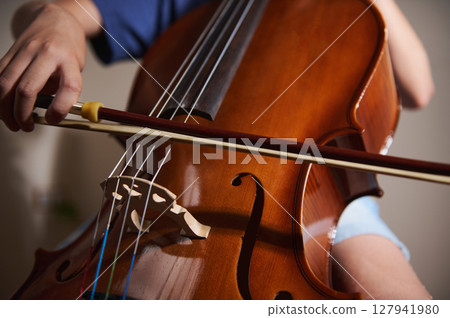 Hands Playing a Cello Using a Bow, Highlighting Music Performance 127941980