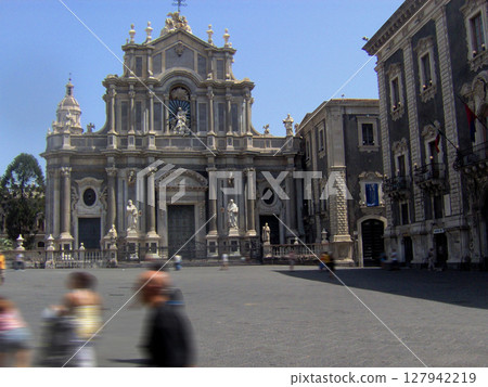 A captivating view of Catania's historic city center, showcasing the harmonious blend of Baroque and Norman architecture. The iconic Catania Cathedral, or Duomo di Sant'Agata, stands prominently in 127942219