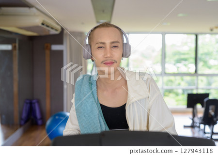 Non-binary person exercising in gym wearing sportswear Non-binary person exercising in gym wearing sportswear 127943118
