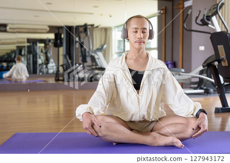 Non-binary person exercising in gym wearing sportswear Non-binary person exercising in gym wearing sportswear 127943172