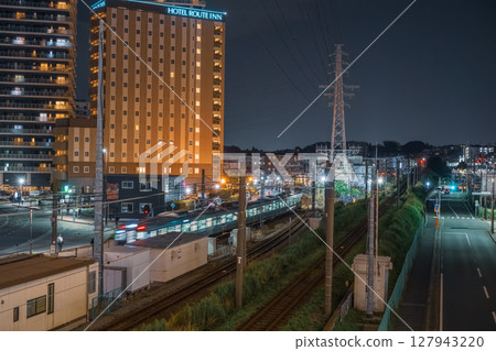 JR Sagami Line train leaving Ebina Station at night 127943220