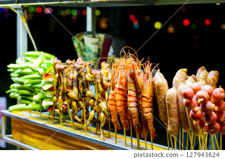 Colorful Vietnamese street food skewers with shrimp, sausages, frogs, and vegetables at night market Colorful Vietnamese street food skewers with shrimp, sausages, frogs, and vegetables at night market 127943624