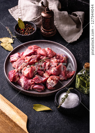 Raw chopped meat with spices 127944044