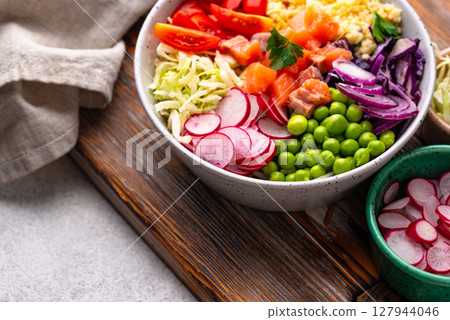 Balanced healthy bowl with vegetables and salmon 127944046