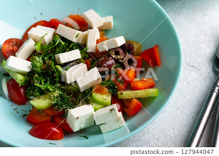 Greek salad with vegetables, olives and feta cheese Greek salad with vegetables, olives and feta cheese 127944047