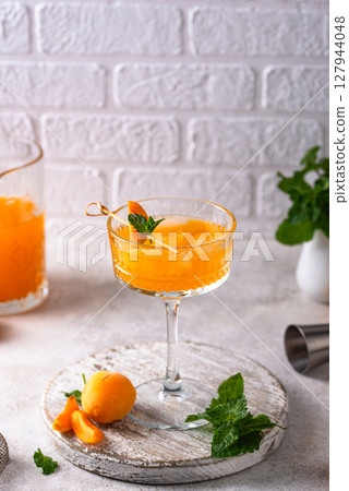 Fresh apricot Bellini cocktail with mint Fresh apricot Bellini cocktail with mint 127944048