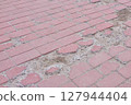 Broken Pavement Reveals Concrete Foundation Below 127944404