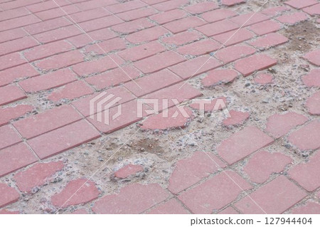 Broken Pavement Reveals Concrete Foundation Below 127944404
