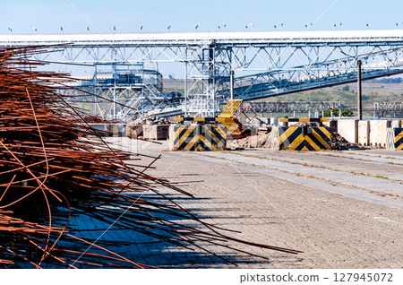 Industrial landscape with pile of rusty rods and modern pipeline 127945072