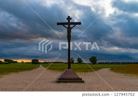 Christian Cross in the sky on two separate paths . Happy Easter. cross beautiful . Sunset or sunrise with clouds 127945702
