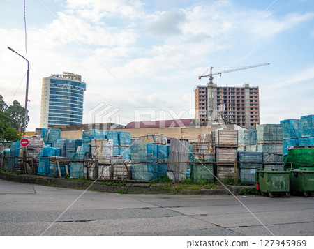 Wholesale market on the street. Warehouse outdoors. Warehouse boxes. Asian market. Salesman . Private enterprise 127945969