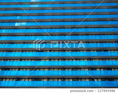 Background from the windows of a modern building. Tall building. Lots of windows. Skyscraper, floors. Human anthill. Modern hostel. Background from the windows of a modern building. Tall building. Lots of windows. Skyscraper, floors. Human anthill. Modern hostel. 127945996