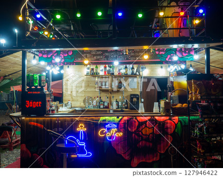 Resort at night. Bar with alcohol in the dark on the beach. Private business. Food kiosk. Rest with alcohol. Party Resort at night. Bar with alcohol in the dark on the beach. Private business. Food kiosk. Rest with alcohol. Party 127946422