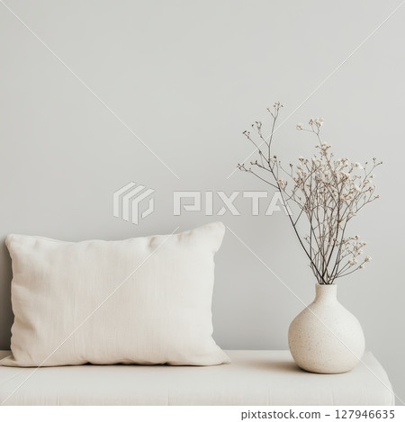 Decorative vase and pillow on neutral backdrop Decorative vase and pillow on neutral backdrop 127946635