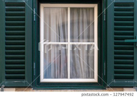 Elegant Window With Closed Green Shutters and Elegant Window With Closed Green Shutters and 127947492