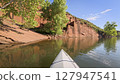 spring kayaking or canoeing in a sandstone canyon along a rocky shore of Horsetooth Reservoir near Fort Collins, Colorado - POV paddler perspective 127947541