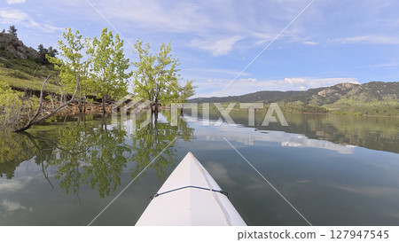 spring kayaking or canoeing on Horsetooth Reservoir at foothills of Rocky Mountains near Fort Collins, Colorado - POV paddler perspective spring kayaking or canoeing on Horsetooth Reservoir at foothills of Rocky Mountains near Fort Collins, Colorado - POV paddler perspective 127947545