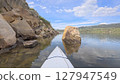 spring kayaking or canoeing in a sandstone canyon along a rocky shore of Horsetooth Reservoir near Fort Collins, Colorado - POV paddler perspective 127947549