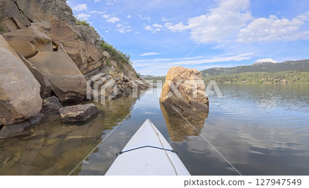 spring kayaking or canoeing in a sandstone canyon along a rocky shore of Horsetooth Reservoir near Fort Collins, Colorado - POV paddler perspective spring kayaking or canoeing in a sandstone canyon along a rocky shore of Horsetooth Reservoir near Fort Collins, Colorado - POV paddler perspective 127947549