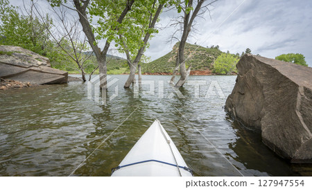 spring kayaking or canoeing on Horsetooth Reservoir at foothills of Rocky Mountains near Fort Collins, Colorado - POV paddler perspective 127947554