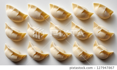 Top Down View of Raw Dumplings Evenly Arranged on White Background 127947867