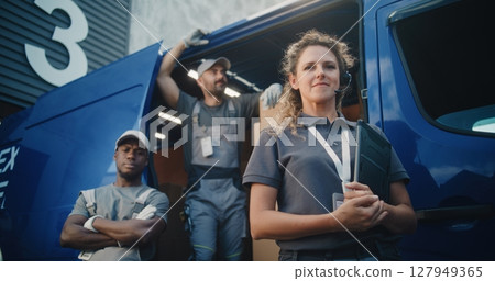 Team of Diverse Workers Standing Outside of Logistics Distribution Warehouse, Looking at Camera 127949365