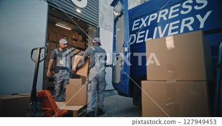 Multiethnic Workers Loading Cardboard Boxes from Pallet Truck in Truck for Shipment Multiethnic Workers Loading Cardboard Boxes from Pallet Truck in Truck for Shipment 127949453
