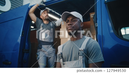 Portrait of Multiethnic Workers Standing Outside of Logistics Retail Warehouse, Looking at Camera Portrait of Multiethnic Workers Standing Outside of Logistics Retail Warehouse, Looking at Camera 127949530