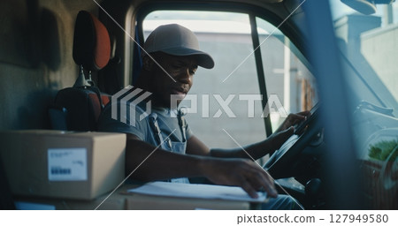 Delivery Truck Driver Sitting in Car, Using Digital Tablet, Filling Out Papers 127949580