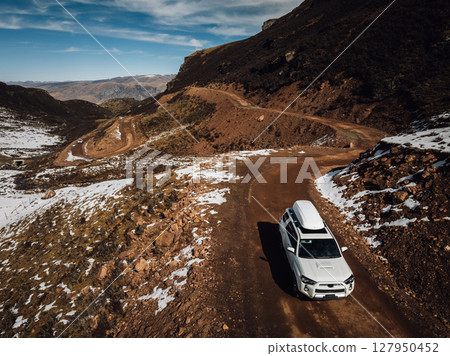 Driving off road car in high altitude mountains in tibet, China Driving off road car in high altitude mountains in tibet, China 127950452
