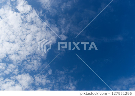 beautiful blue sky and white fluffy group of clouds with sunrise in the morning, natural background 127951296