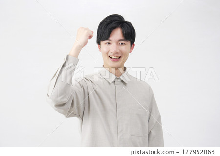 Man in his 20s, fist pump, white background 127952063