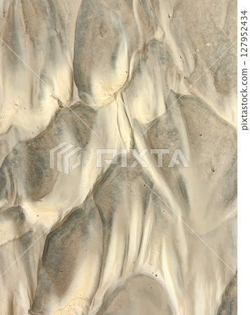 unique patterns sand and clay create textured landscape in natural setting. closeup. unique patterns sand and clay create textured landscape in natural setting. closeup. 127952434