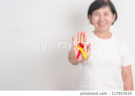 World hepatitis day awareness month, 28 July. elderly woman with Red and Yellow ribbon. Liver cancer, Jaundice, Cirrhosis, Failure, Enlarged, Hepatic Encephalopathy and Health concept 127952610